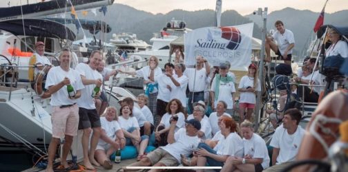 Rob, the team and all the participants from Croatia gather on a pontoon in their white Oceans of Hope t-shirts and celebrate with a bottle of champagne